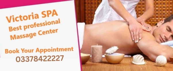 A female message specialist performing massage therapy on a male client's back at Victoria massage center Islamabad